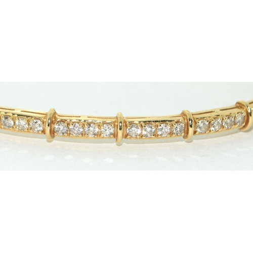 539 - A 14ct Gold & Diamond set Hinged Bangle. Approx 9.4g