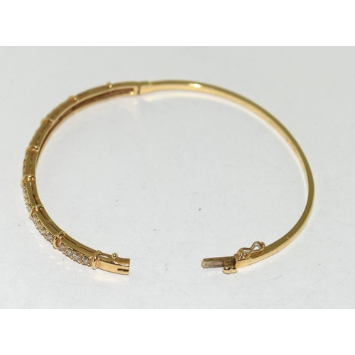 539 - A 14ct Gold & Diamond set Hinged Bangle. Approx 9.4g