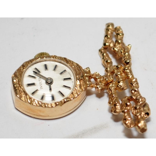 442 - 9ct gold brooch watch by Invicta. Watch winds and runs