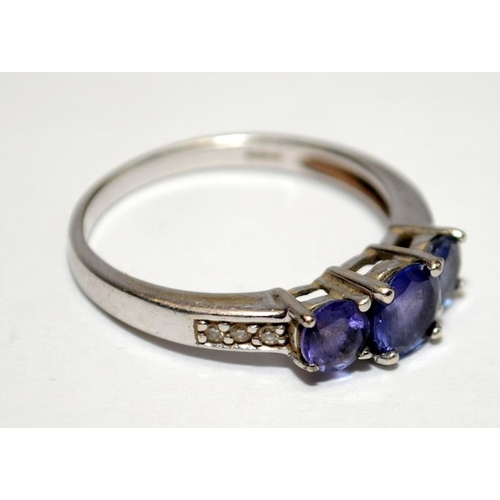 406 - A 925 silver three stone amethyst ring Size N.