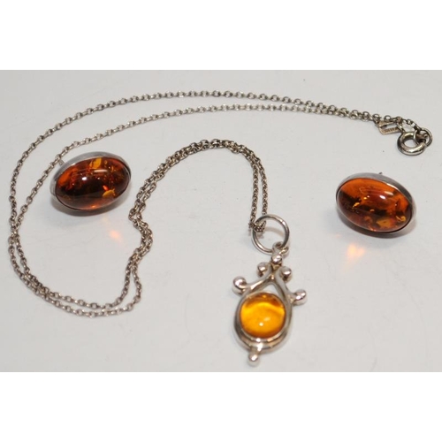 381 - Boxed Baltic amber pendant and earrings.