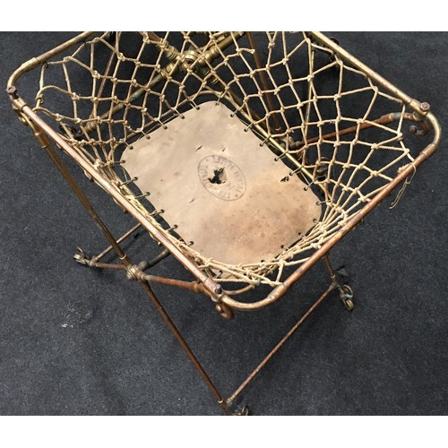 240 - Antique brass child's folding cot on castors together with matching nappy changing basket (2).