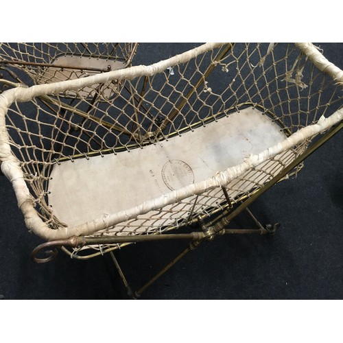 240 - Antique brass child's folding cot on castors together with matching nappy changing basket (2).