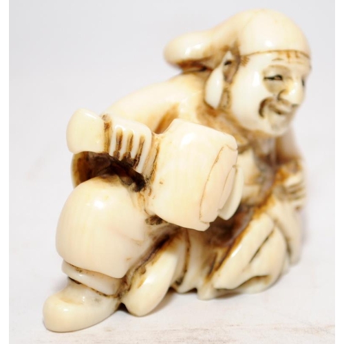 287 - Antique Netsuke depicting a seated old man. Signed to underside