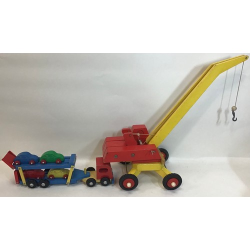 129 - Wooden toys to include crane - car transporter with 4 small cats - Baby boxed piano and boxed Matado... 