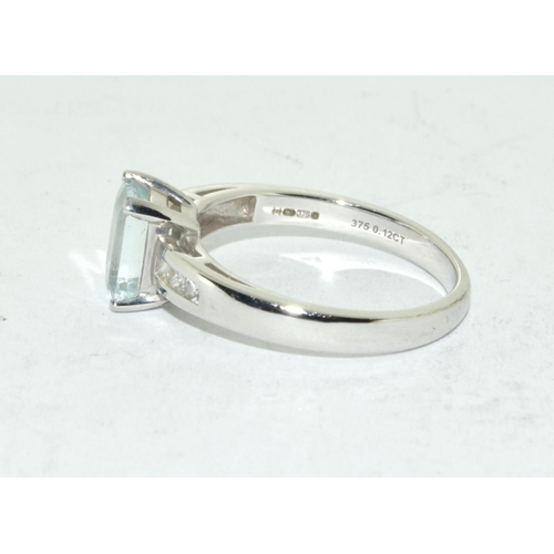 461 - Aquamarine Emerald cut ring set in 9ct white gold with diamond shoulders . Size N