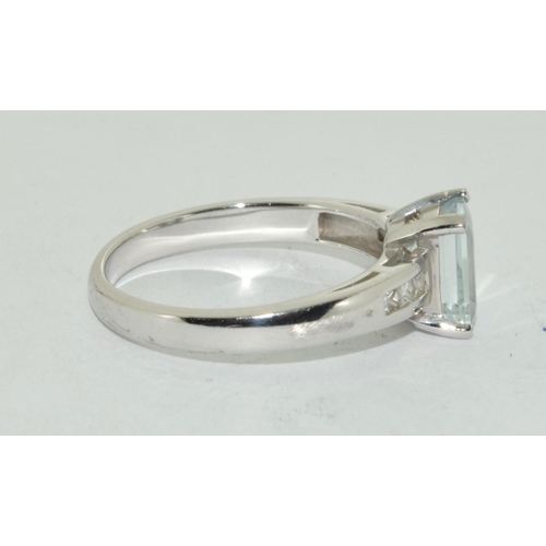 461 - Aquamarine Emerald cut ring set in 9ct white gold with diamond shoulders . Size N