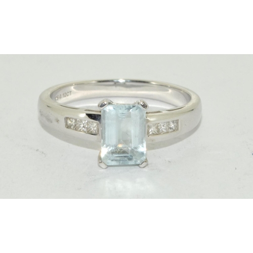 461 - Aquamarine Emerald cut ring set in 9ct white gold with diamond shoulders . Size N