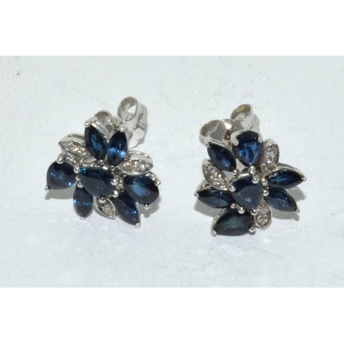 527 - Diamond & sapphire flower stud earrings set in 9ct white gold.