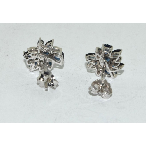 527 - Diamond & sapphire flower stud earrings set in 9ct white gold.