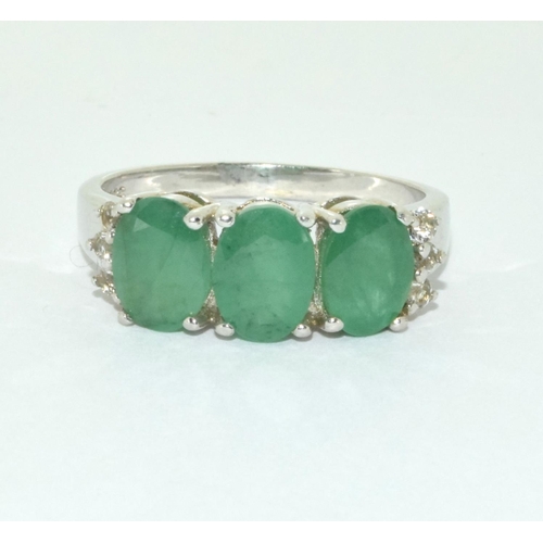 493 - A three stone possibly emerald silver ring Size U