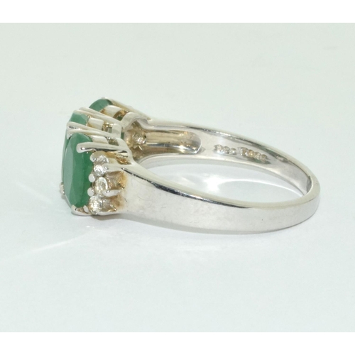 493 - A three stone possibly emerald silver ring Size U