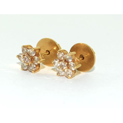 414 - Diamond Daisy earrings set in 18ct gold mounts.