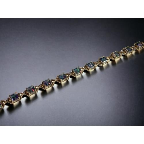 514 - 9ct gold ladies Mystic Topaz line bracelet 21cm long