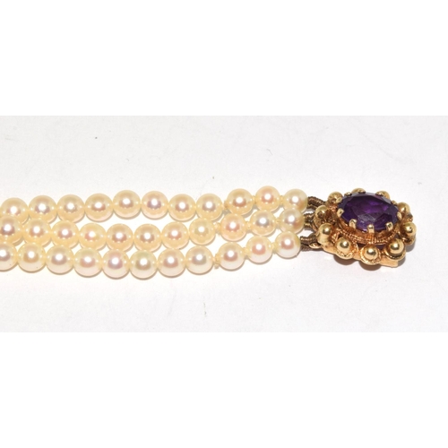 459 - 3 string  Vintage Pearl bracelet set with 9ct gold clasp with a central Amethyst stone