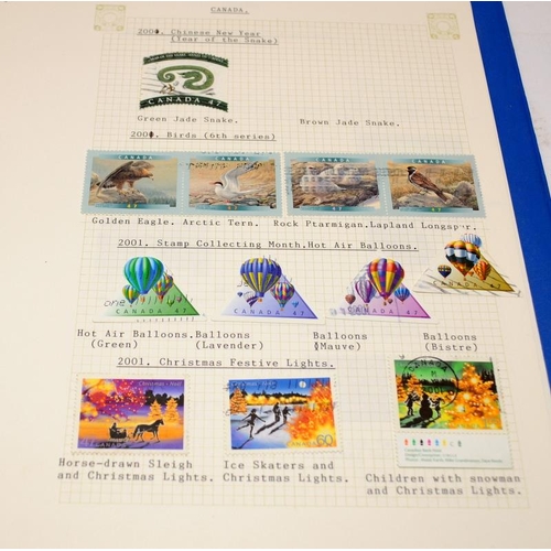 215 - 4 albums containing a collection of stamps issued by USA and Canada. All well presented