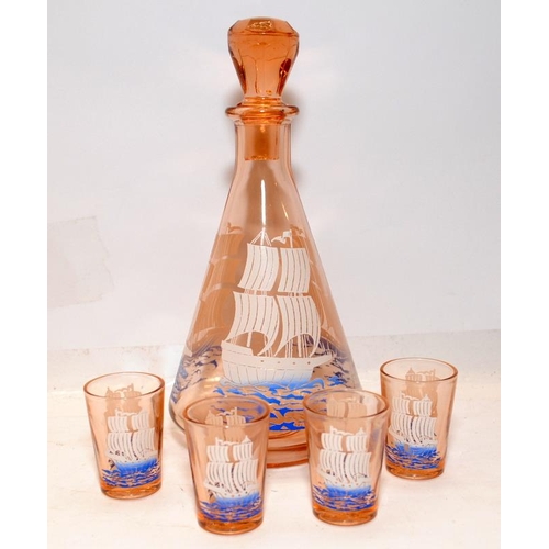 66 - Vintage mid-century peach glass decanter featuring a ship c/w four shot glasses