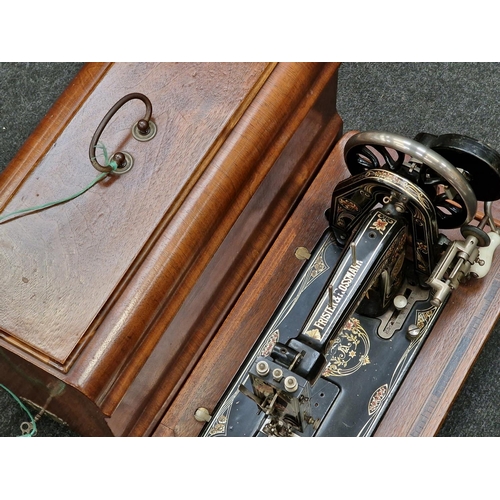 242 - Antique Frister & Rossmann sewing machine in wooden case.