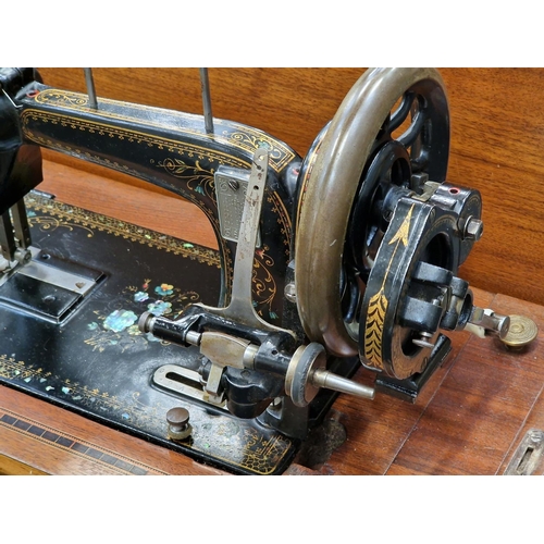 260 - Antique sewing machine in wooden case.