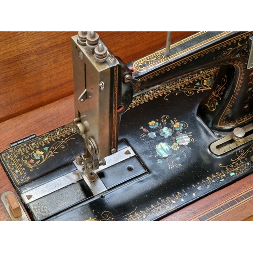 260 - Antique sewing machine in wooden case.