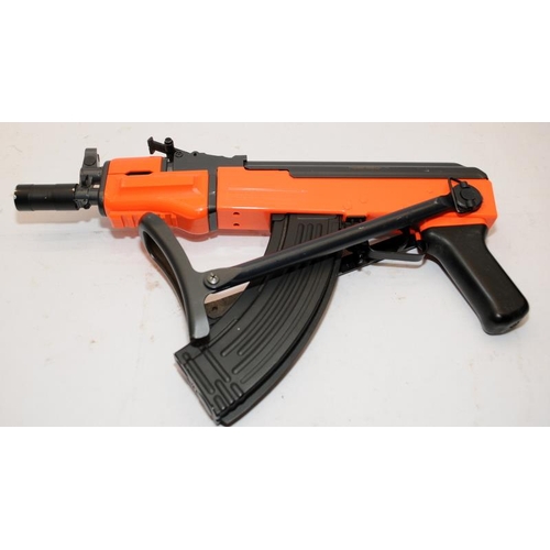 165 - BB gun in the style of an AK47 machine gun. Orange / black two tone body. Untested