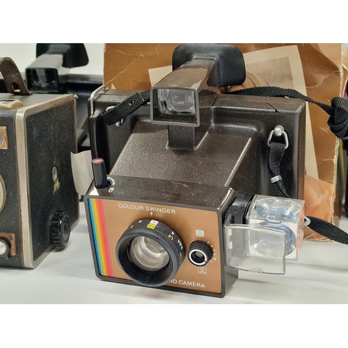 158 - Collection of vintage cameras and equipment to include Polaroid instant cameras.