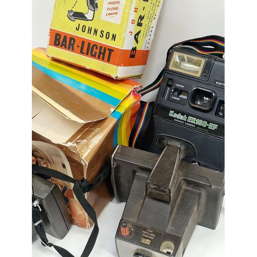 158 - Collection of vintage cameras and equipment to include Polaroid instant cameras.