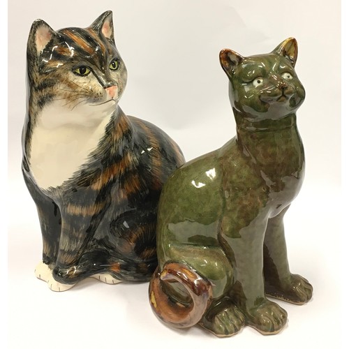 87 - Two ceramic cat figurines the largest measuring 31cm.