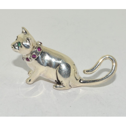 424 - A silver cat figure with ruby set collar.