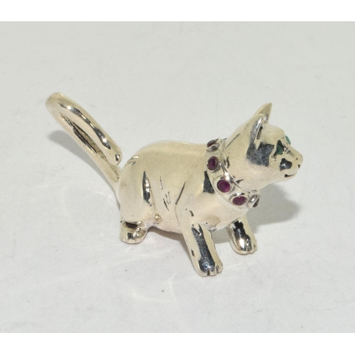 424 - A silver cat figure with ruby set collar.