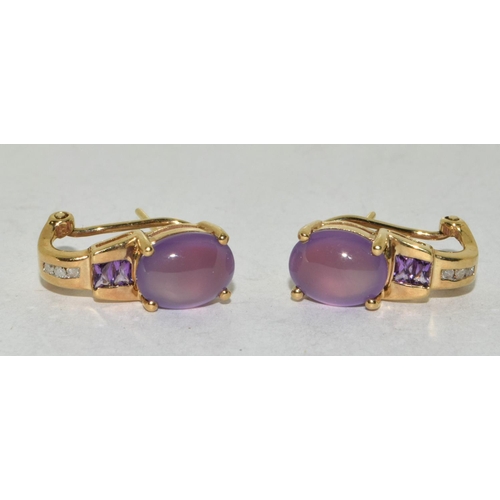 519 - A pair of 10ct yellow gold cabachon amethyst earrings.