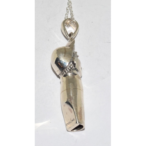 525 - Silver whistle in figural form on silver chain.