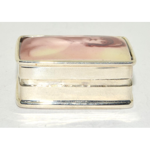 504 - A silver pill box with nude enamel image of a lady.