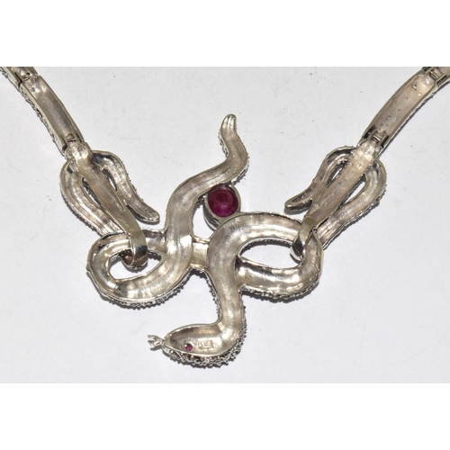 404 - A silver ruby set snake necklace.