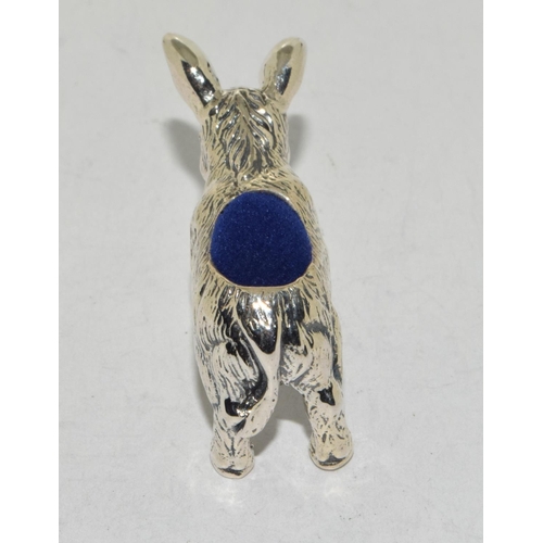 507 - A silver pin cushion in the form of a donkey with sapphire eyes.