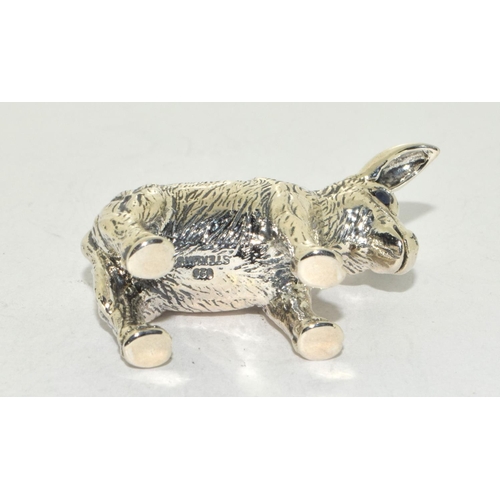 507 - A silver pin cushion in the form of a donkey with sapphire eyes.