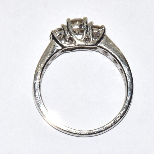 518 - A white gold three stone diamond ring of 90 points flanked by baguette shoulders Size N