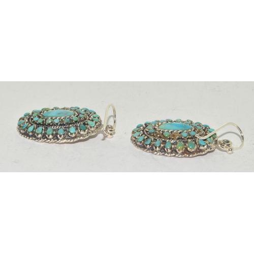 384 - A pair of substantial silver and turquoise drop earrings.