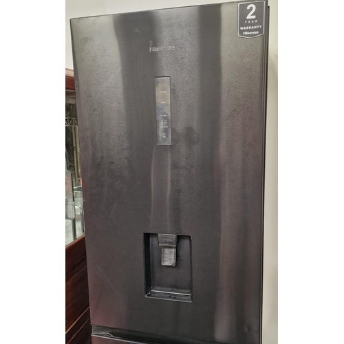 379 - A Hisense black modern fridge freezer. Looks to have been barely used.185x58x57cm.