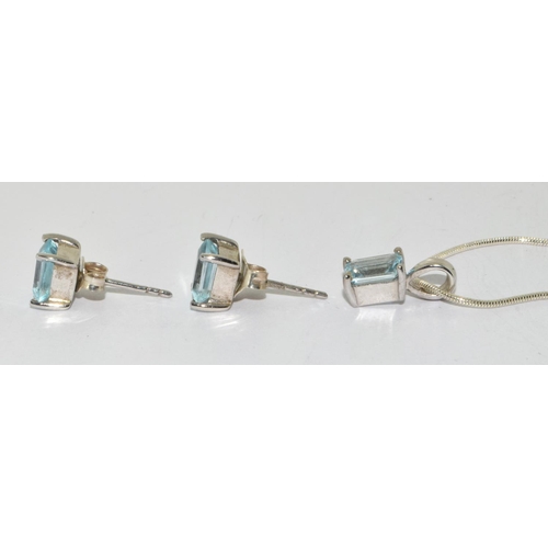 196 - Emerald cut blue topaz 925 silver pendant and earrings.