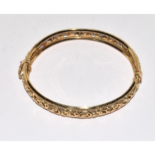 312 - 9ct gold open work bangle with spring closed mechanism