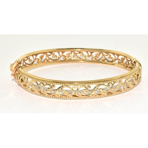 312 - 9ct gold open work bangle with spring closed mechanism