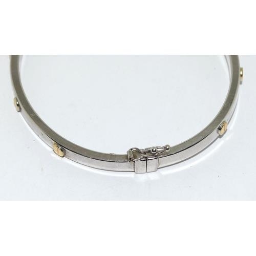 382 - 9ct white gold ladies bangle in the Cartier love bangle design