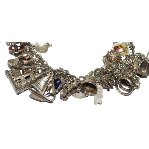 89 - Good silver charm bracelet and charms approx 25, 80g