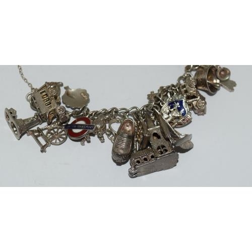 89 - Good silver charm bracelet and charms approx 25, 80g