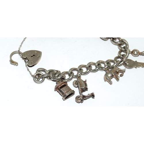 98 - Silver charm bracelet and charms (10) 53g