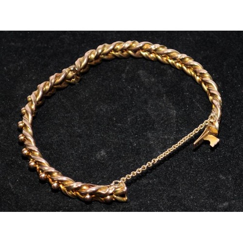 367 - 9ct gold bangle with rope twist decoration and safety chain