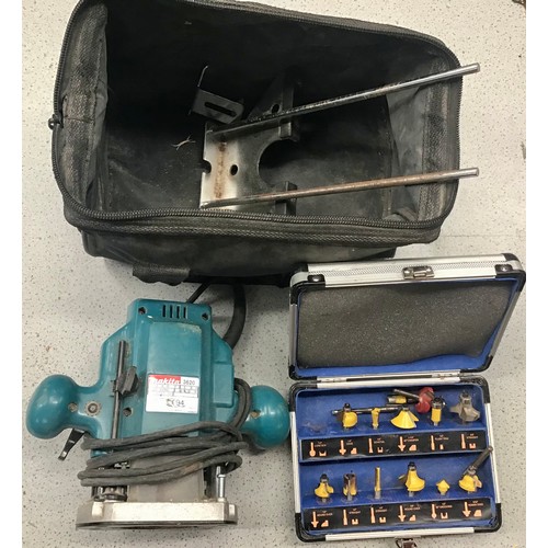 74 - A Makita Router with various attachments and bag.