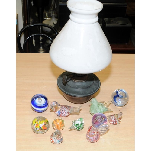 90 - A collection of glass paperweights, many in the form of birds, together with an antique oil lamp wit... 