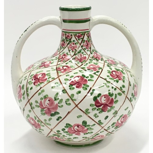 106 - Wemyss style pottery hand painted twin handled vase painted with roses. Impressed numbers to base 27... 